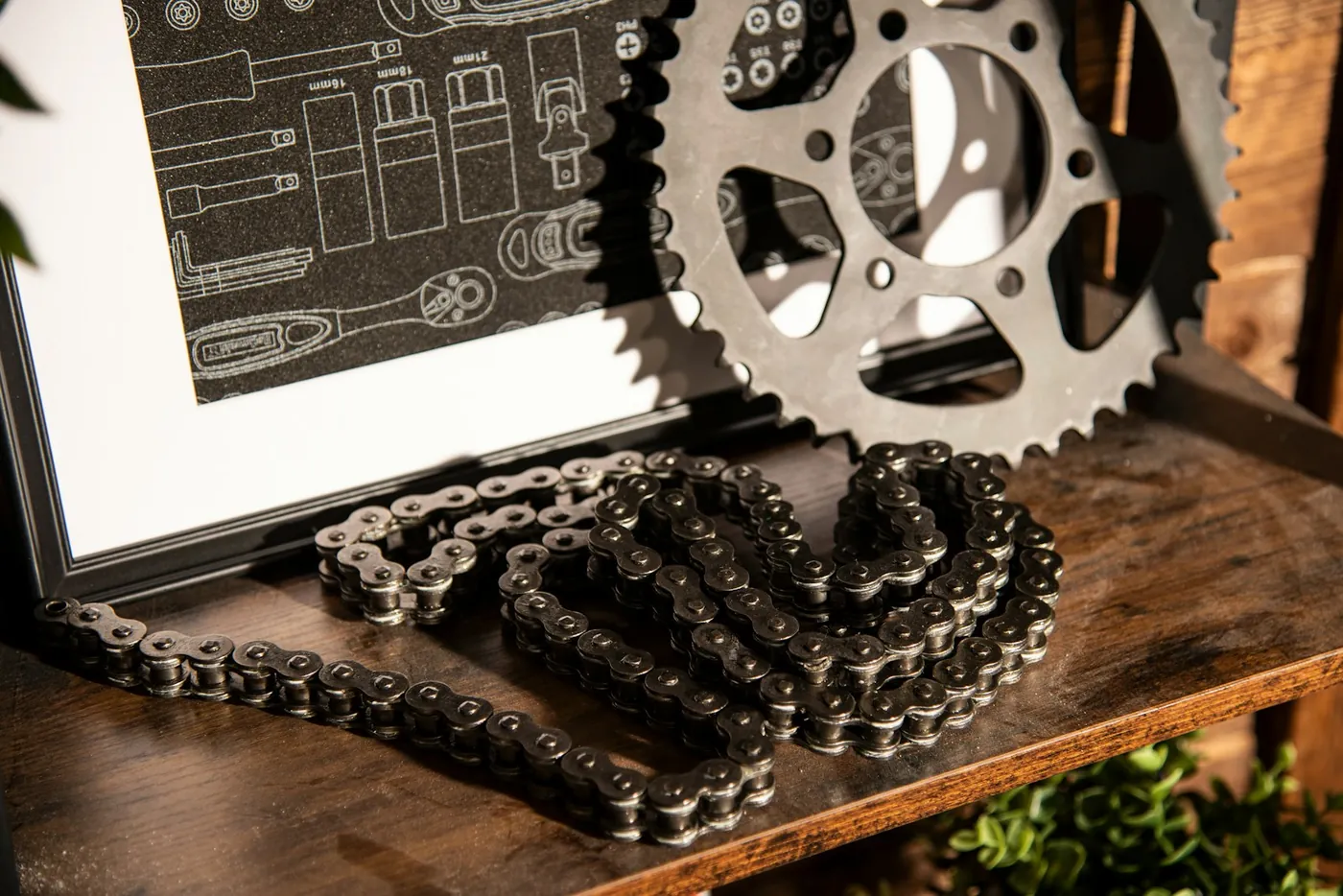 Motorcycle chain and sprocket on a workshop shelf
