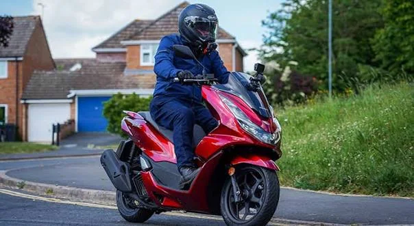 Rider on a red Honda PCX